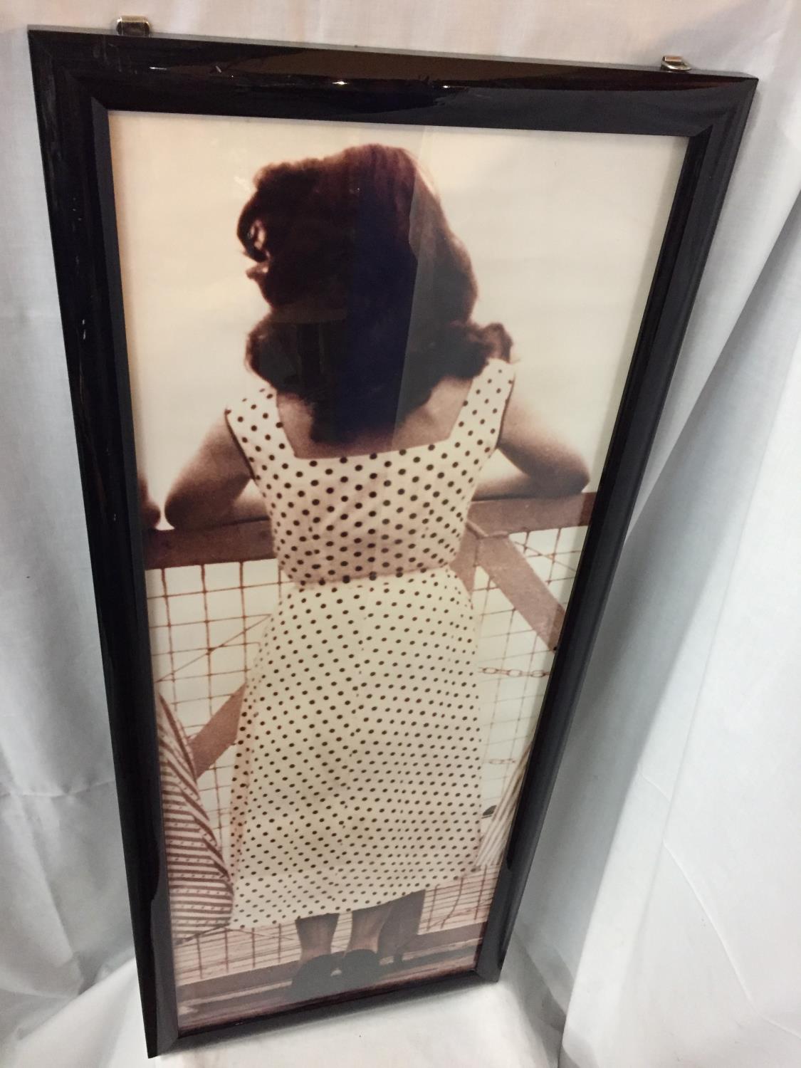 A LARGE BLACK FRAMED ORIGINAL KODAK PRINT OF A 1940'S LADY IN A POLKA DOT DRESS AND SEAMED STOCKINGS - Image 2 of 2