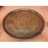 A LARGE BRASS CHARGER 58CM DIAMETER