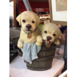 A RESIN GARDEN ORNAMENT OF TWO GOLDEN LABRADOR PUPPIES