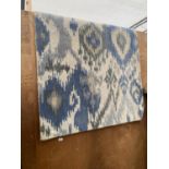 A MODERN BLUE AND CREAM PATTERNED RUG