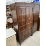 AN EARLY 20TH CENTURY OAK TWO DOOR WARDROBE, 36" WIDE