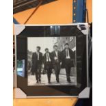 A FRAMED PHOTOGRAPH OF THE BEATLES