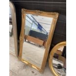 A DECORATIVE GILT FRAMED WALL MIRROR