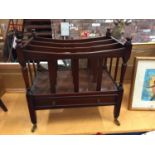 A MAHOGANY CANTERBURY MAGAZINE RACK ON VINTAGE CASTERS