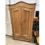 A CONTINENTAL TWO DOOR VICTORIAN WARDROBE WITH DRAWER TO THE BASE AND ARCHED PEDIMENT 42" WIDE