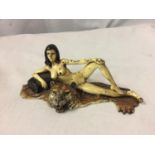 A COLD PAINTED BRONZE FIGURINE OF A NUDE LADY LYING ON A TIGER RUG