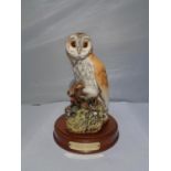 A ROYAL DOULTON BARN OWL ON A PLINTH