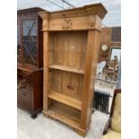 A MODERN PINE OPEN BOOKCASE WITH VIOLIN CARVING TO THE PEDIMENT, 43" WIDE