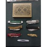 A DECORATIVE METAL TIN AND A SMALL SELECTION OF PEN KNIVES