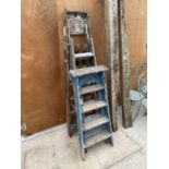 TWO FOUR RUNG WOODEN STEP LADDERS AND A FURTHER SIX RUNG WOODEN STEP LADDER