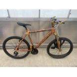 A GENT'S MOUNTAIN BIKE WITH FRONT SUSPENSION AND 21 SPEED TOURNEY GEAR SYSTEM