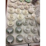 A LARGE COLLECTION OF VARIOUS TEA CUPS AND SAUCERS OF VARIOUS DESIGNS AND TWO TEAPOTS