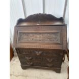 A VICTORIAN HEAVILY CARVED OAK BUREAU WITH LION MASK HANDLE, 35" WIDE