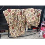 A PAIR OF FLORAL CURTAINS WITH PELMETS