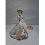 TWO NAO FIGURES, ONE OF A SLEEPING DOG IN A BASKET AND A SECOND OF A GIRL AND A PUPPY