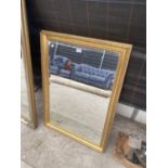 A DECORATIVE GILT FRAMED MIRROR