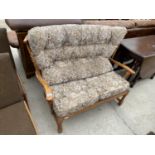 A MODERN WINGED TWO SEATER COTTAGE SETTEE