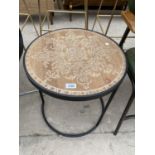 A CIRCULAR OCCASIONAL TABLE ON BLACK METALWARE FRAME AND INDUSTRIAL STYLE ARMCHAIR
