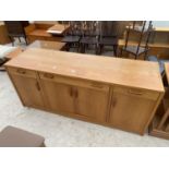 A RETRO TEAK SIDEBOARD ENCLOSING FOUR CUPBOARDS, THREE DRAWERS, 67" WIDE