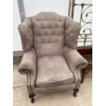 A GEORGIAN STYLE WINGED EASY CHAIR ON CABRIOLE LEGS