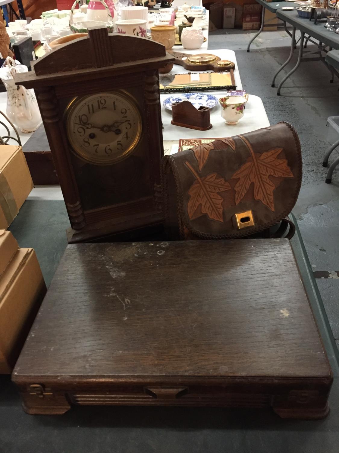 A WOODEN CLOCK, A BOX OF FLATWARE AND A SMALL LEATHER BAG WITH LEAF DESIGN