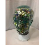 A LIFE SIZED GLASS HEAD FILLED WITH MIXED VINTAGE AND MODERN MARBLES, APPROX HEIGHT 28CMS