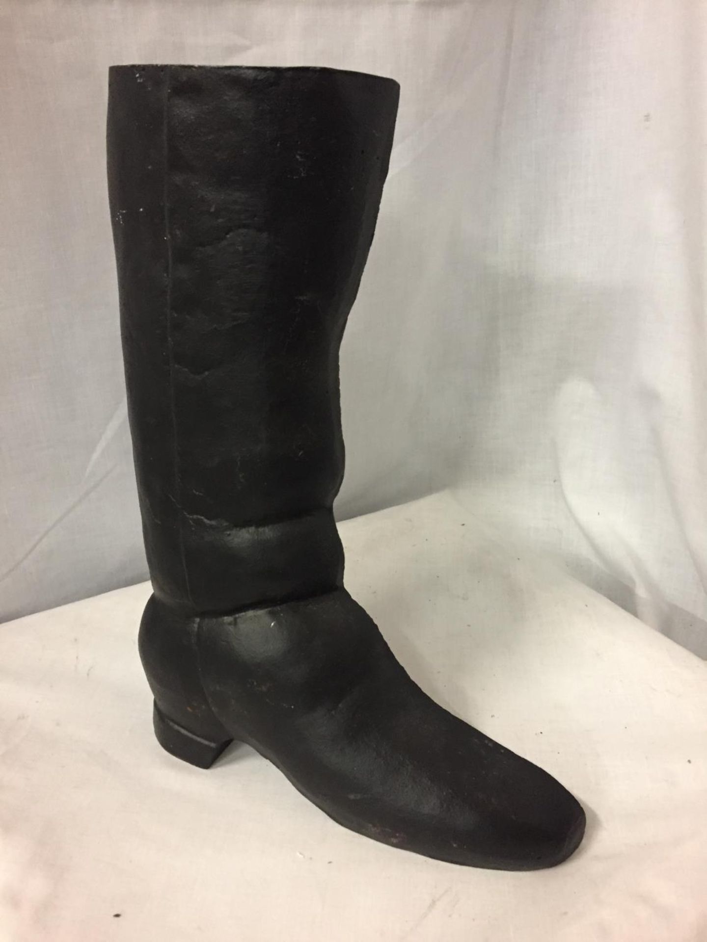 A CAST IRON BOOT SHAPED DOOR STOP