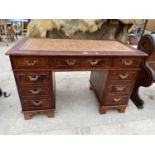 A REPRODUCTION TWIN PEDESTAL DESK OF NINE DRAWERS, WITH INSET LEATHER TOP, 48" X 24"