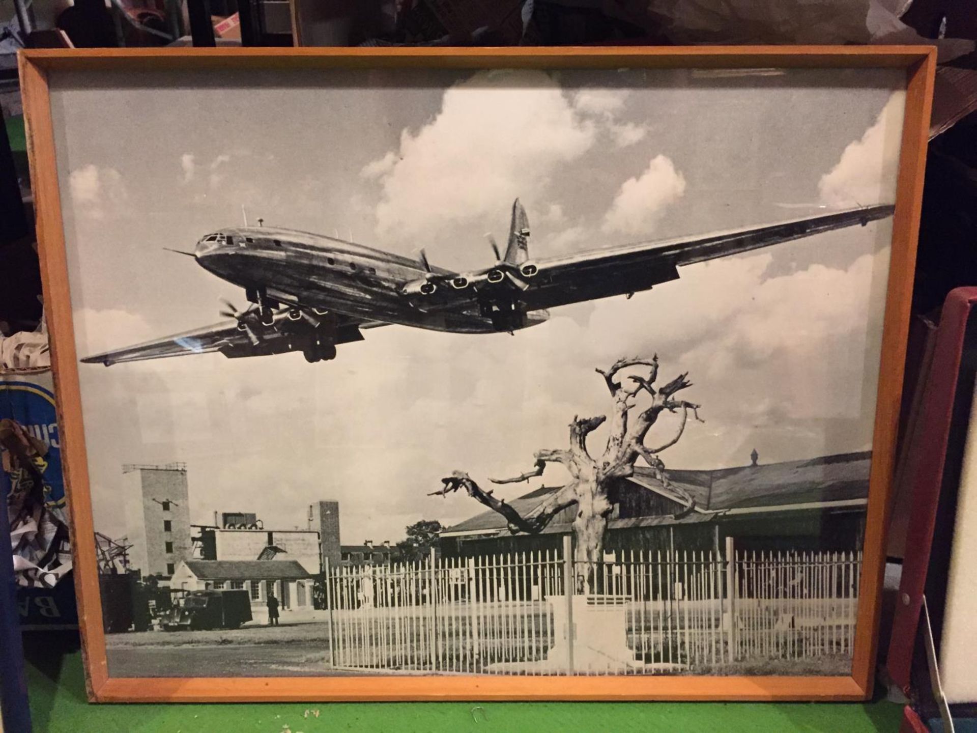 A FRAMED BLACK AND WHITE PHOTOGRAPH ON AN AEROPLANE TAKING OFF