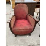 A MID 20TH CENTURY LOW FIRESIDE CHAIR WITH U-SHAPED FRONT AND SPRUNG SEAT