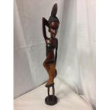 A CARVED WOODEN TRIBAL FIGURE OF A LADY H:65CM