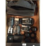 A SELECTION OF CAMERAS AND EQUIPMENT TO INCLUDE TWO OLYMPUS TRIP 35 CAMERAS, LENSES, BINOCULARS ETC.
