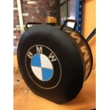 A BLACK BMW PETROL CAN WITH A BRASS TOP