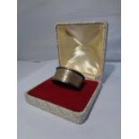 A BOXED SILVER NAPKIN RING