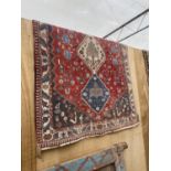 A RED AND BLUE PATTERNED RUG (115CM X 160CM)