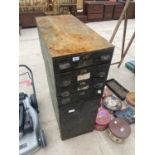 A VINTAGE METAL WORKSHOP STORAGE UNIT ENCLOSING FOUR DRAWERS AND A CUPBOARD