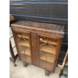 AN EARLY 20TH CENTURY OAK TWO DOOR CHINA CABINET, 36" WIDE