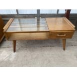 A G-PLAN E-GOMME OAK TWO TIER COFFEE TABLE WITH PARTIAL GLASS TOP AND DOUBLE SIDED DRAWER