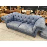 A BLUE LEATHER CHESTERFIELD STYLE SETTEE ON TURNED LEGS