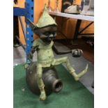 A VERY LARGE BRONZE FIGURE OF A PIXIE SITTING ON A EWER WITH A SNAIL