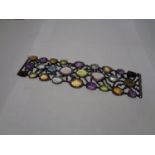 AN ART DECO STYLE DIAMOND, CITRINE, AMETHYST AND MULTI GEMSTONE BRACELET