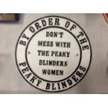 A CAST 'BY ORDER OF THE PEAKY BLINDERS' SIGN, DIAMETER 24CM