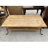 A MODERN PINE TWO TIER COFFEE TABLE, 54" X 28", ON CAST IRON SCROLL LEGS