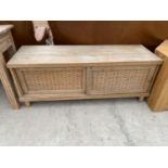 A HARDWOOD TV/VIDEO STAND WITH SLIDING DOORS, INSET WITH RATTAN, 55" WIDE