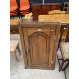 A GEORGE III OAK AND CROSSBANDED CORNER CUPBOARD WITH SHAPED INTERIOR SHELVES