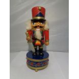 A STEINBACH STYLE NUTCRACKER ON A MUSIC BOX BASE