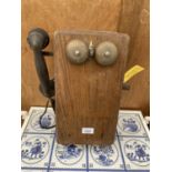A VINTAGE WOODEN WALL MOUNTED TELEPHONE