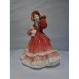 A ROYAL DOULTON FIGURINE CHRISTMAS TIME HN2110