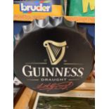 A BOTTLE CAP SIGN 'GUINESS DRAUGHT'