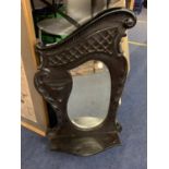 A DECORATIVE WALL MOUNTED MIRROR WITH SHELF